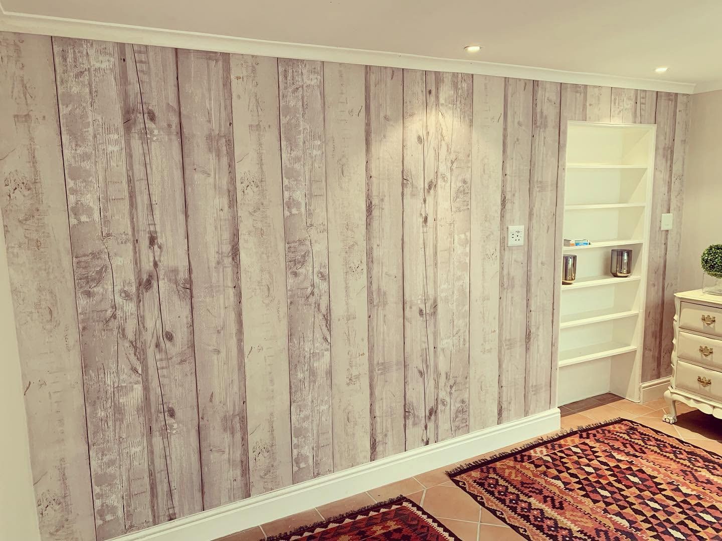 Finished whitewashed wood-plank wallpaper on the bedroom wall