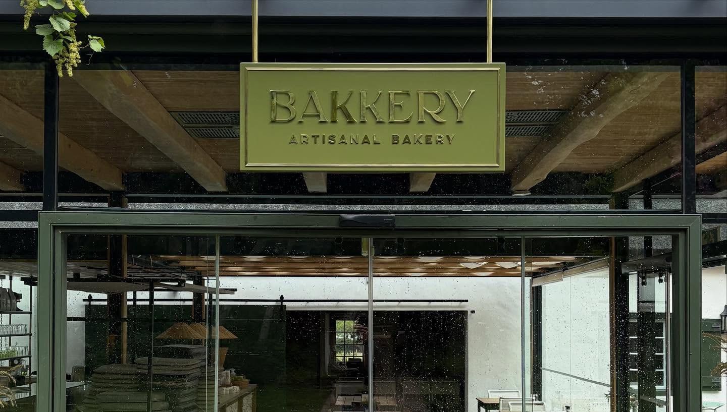 Bakkery sign hanging over the glass entrance of the estate bakery