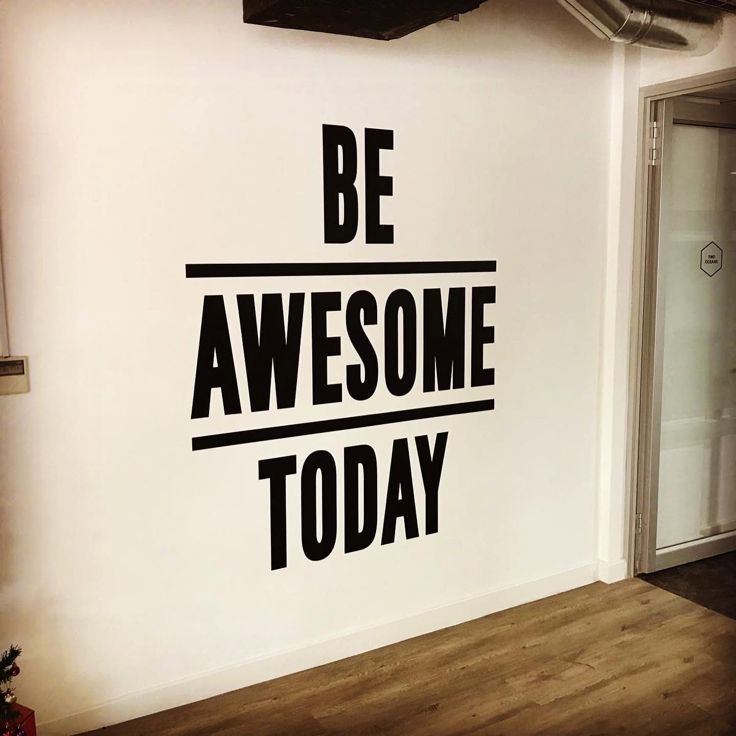 Cut vinyl lettering reading Be Awesome Today on an office wall