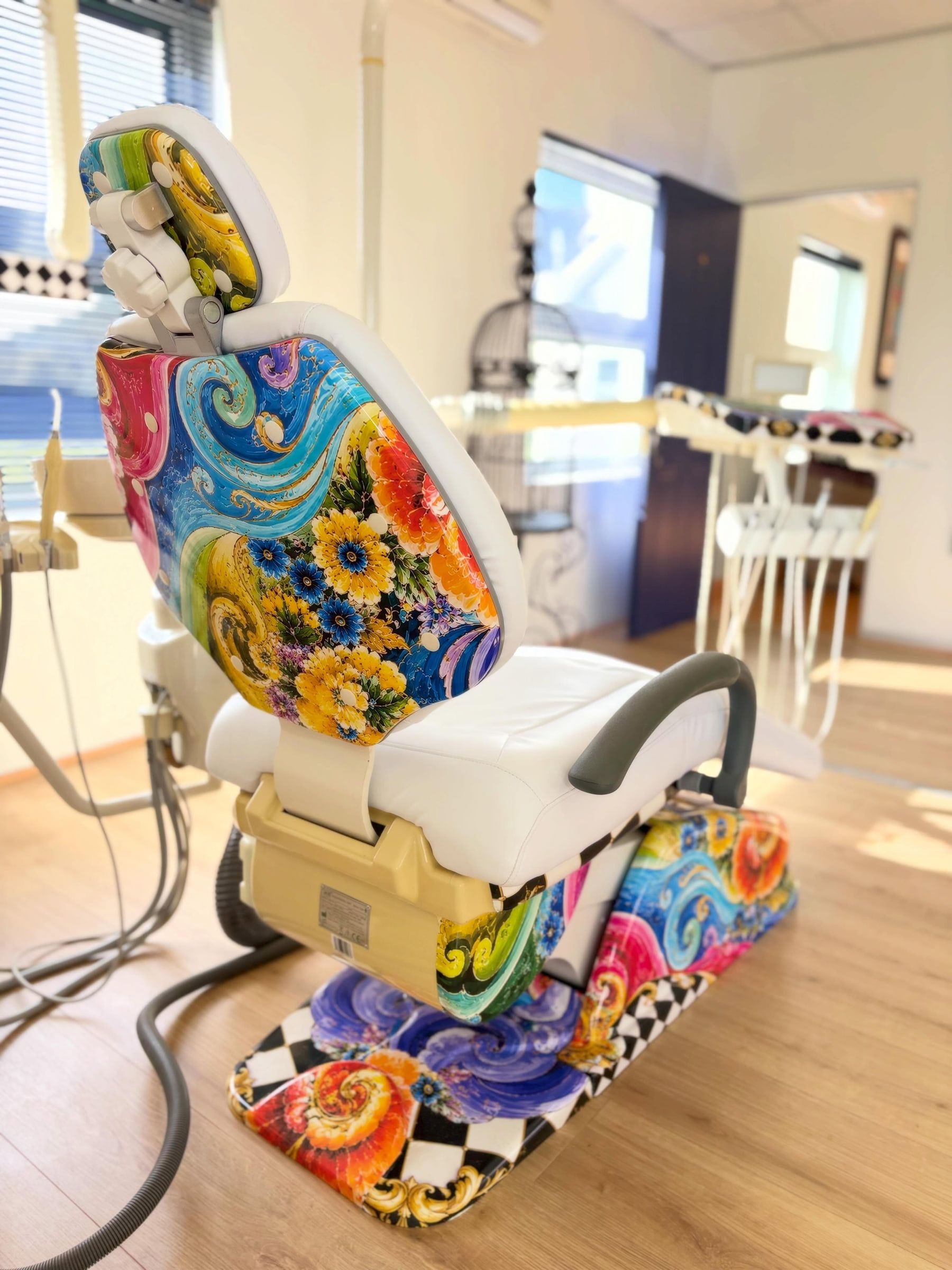 Back of a dental chair wrapped in sunflowers and swirling colour