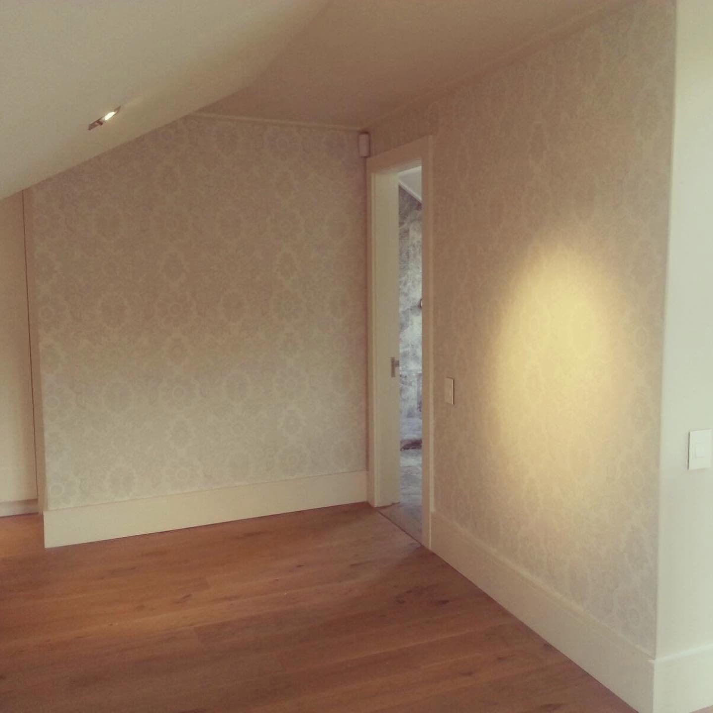 Pale damask wallpaper on a landing wall
