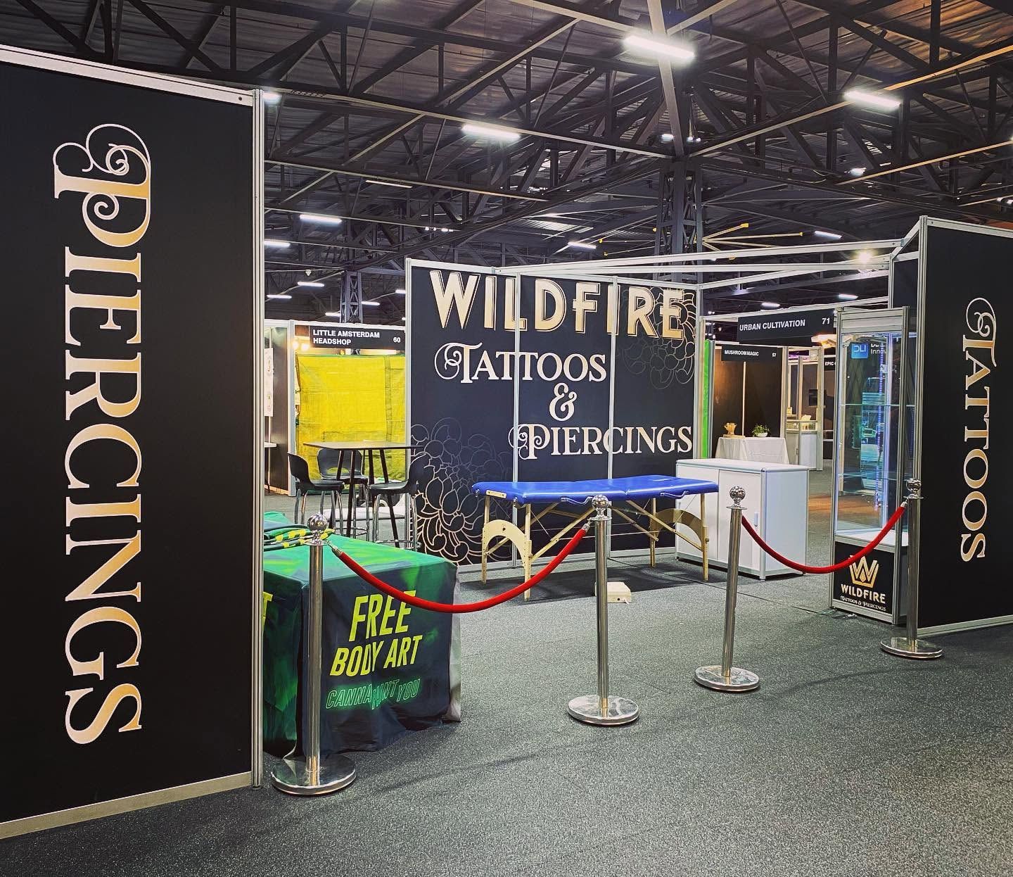 Exhibition booth wrapped in black and gold Wildfire graphics