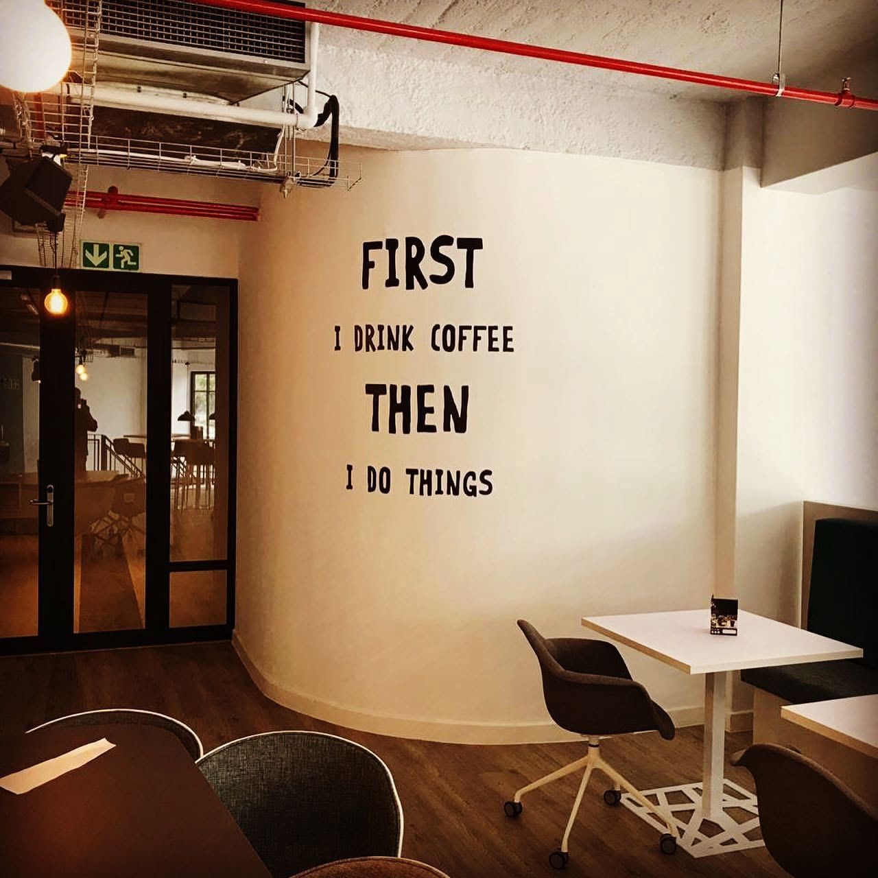 Wall lettering reading First I drink coffee, then I do things