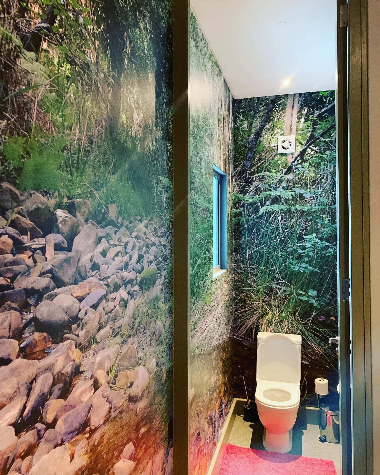 Fynbos and forest mural wrapping a narrow bathroom