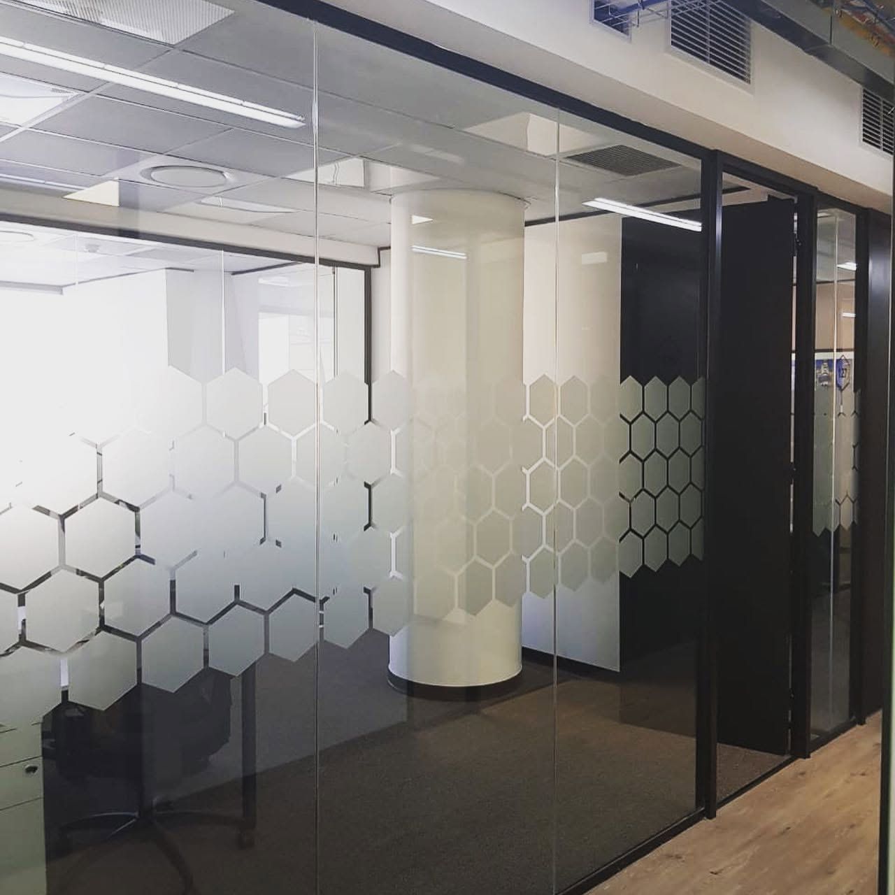 Frosted hexagon pattern film on office glass partitions