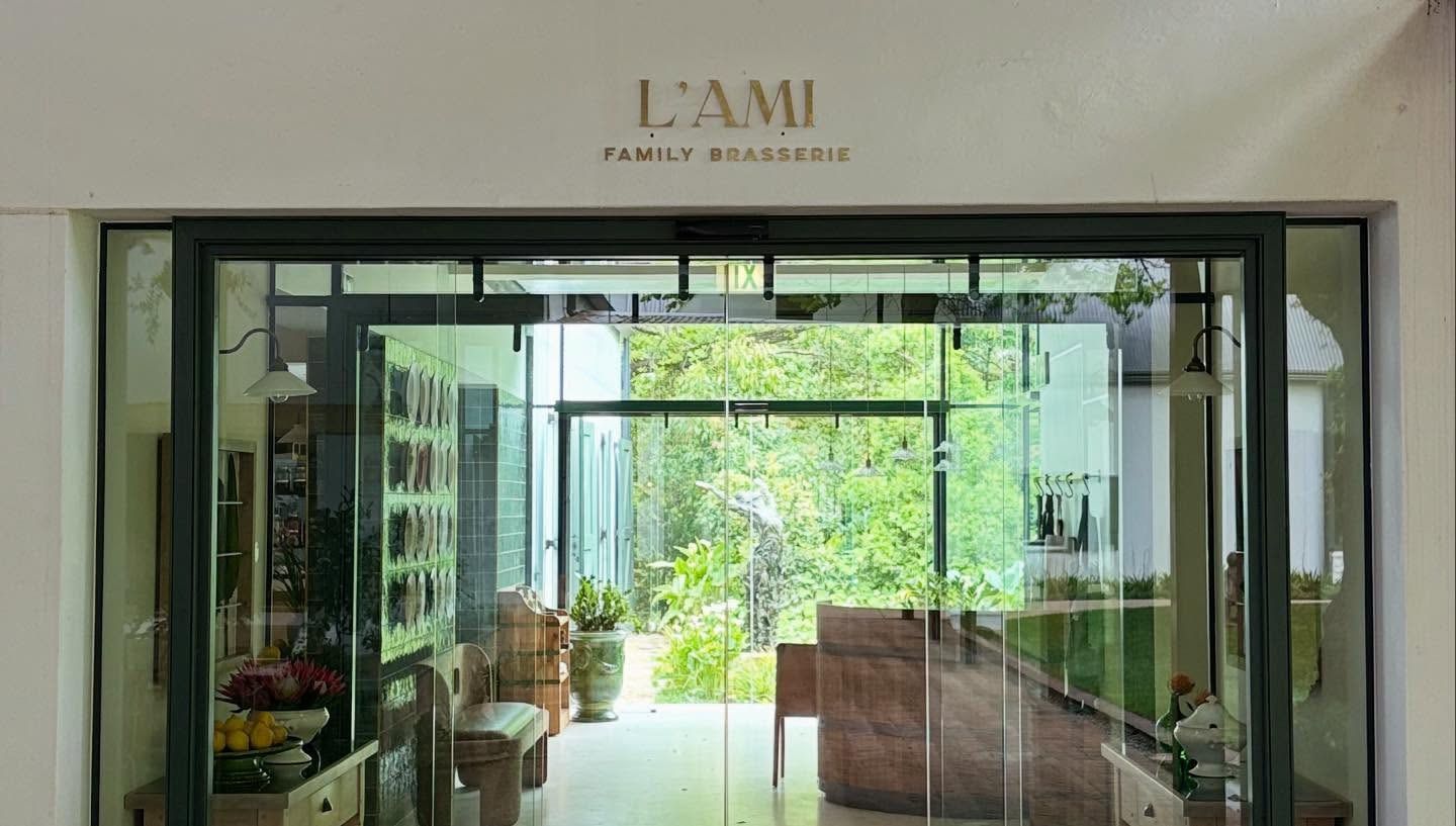 L'Ami Family Brasserie lettering above a glass shopfront