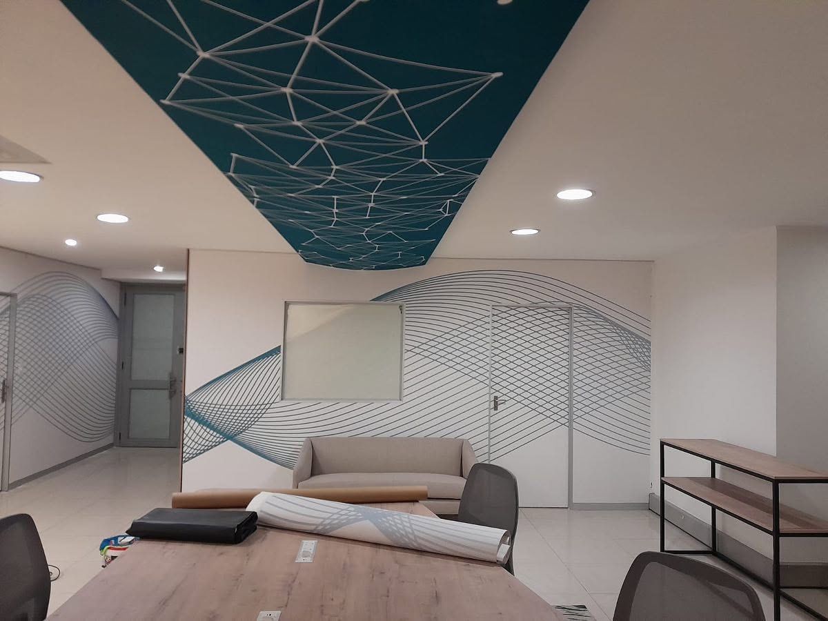 Office lounge with wave wall graphic and printed ceiling
