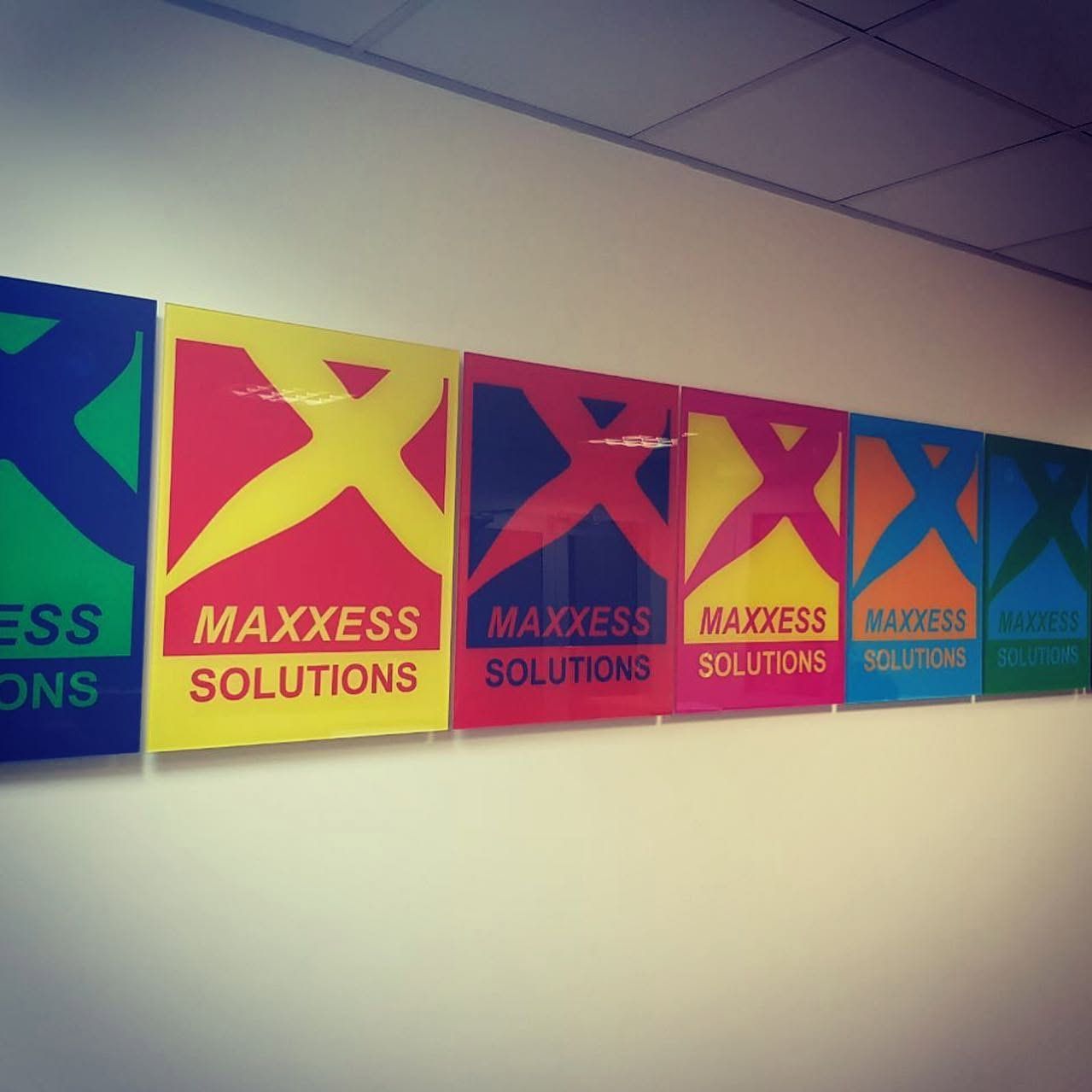 Row of colourful printed acrylic panels for Maxxess Solutions