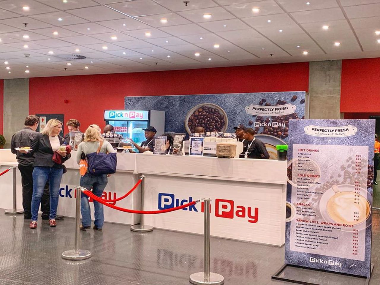 Branded Pick n Pay coffee counter and menu boards at an indoor event