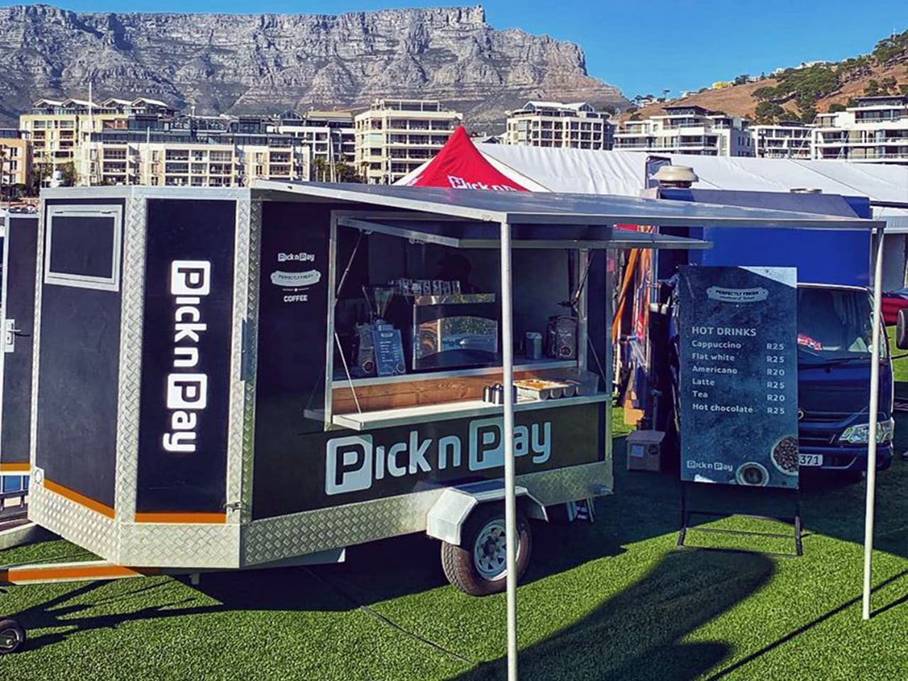Pick n Pay coffee trailer branded in navy at an event below Table Mountain