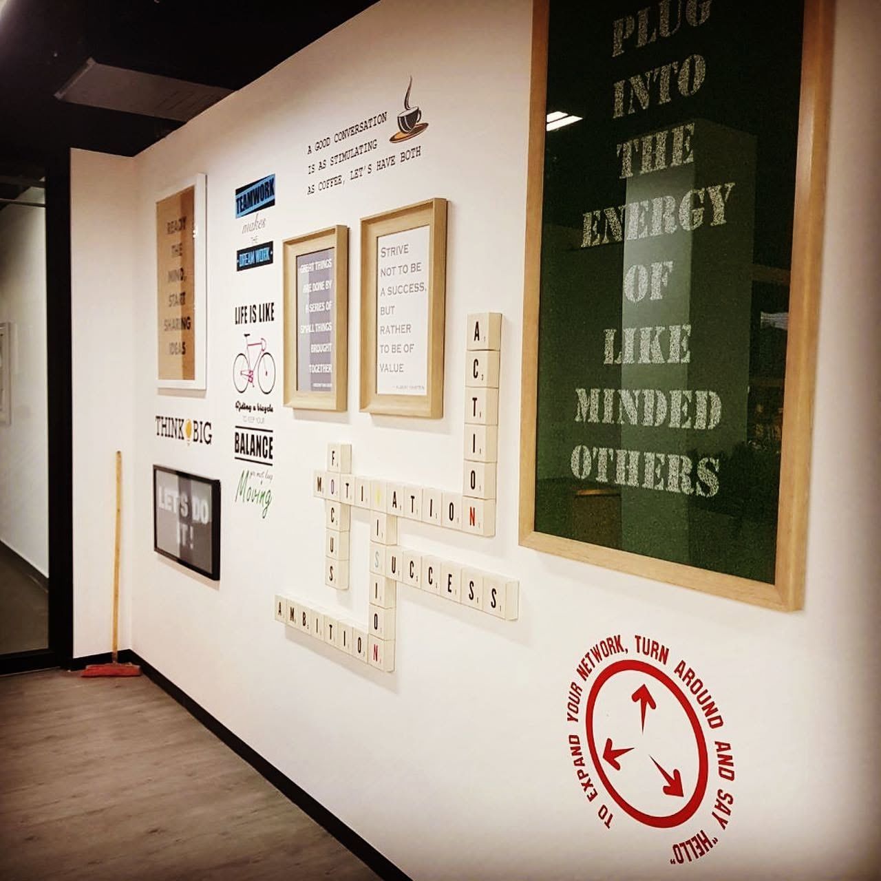 Office feature wall with framed quotes and printed panels
