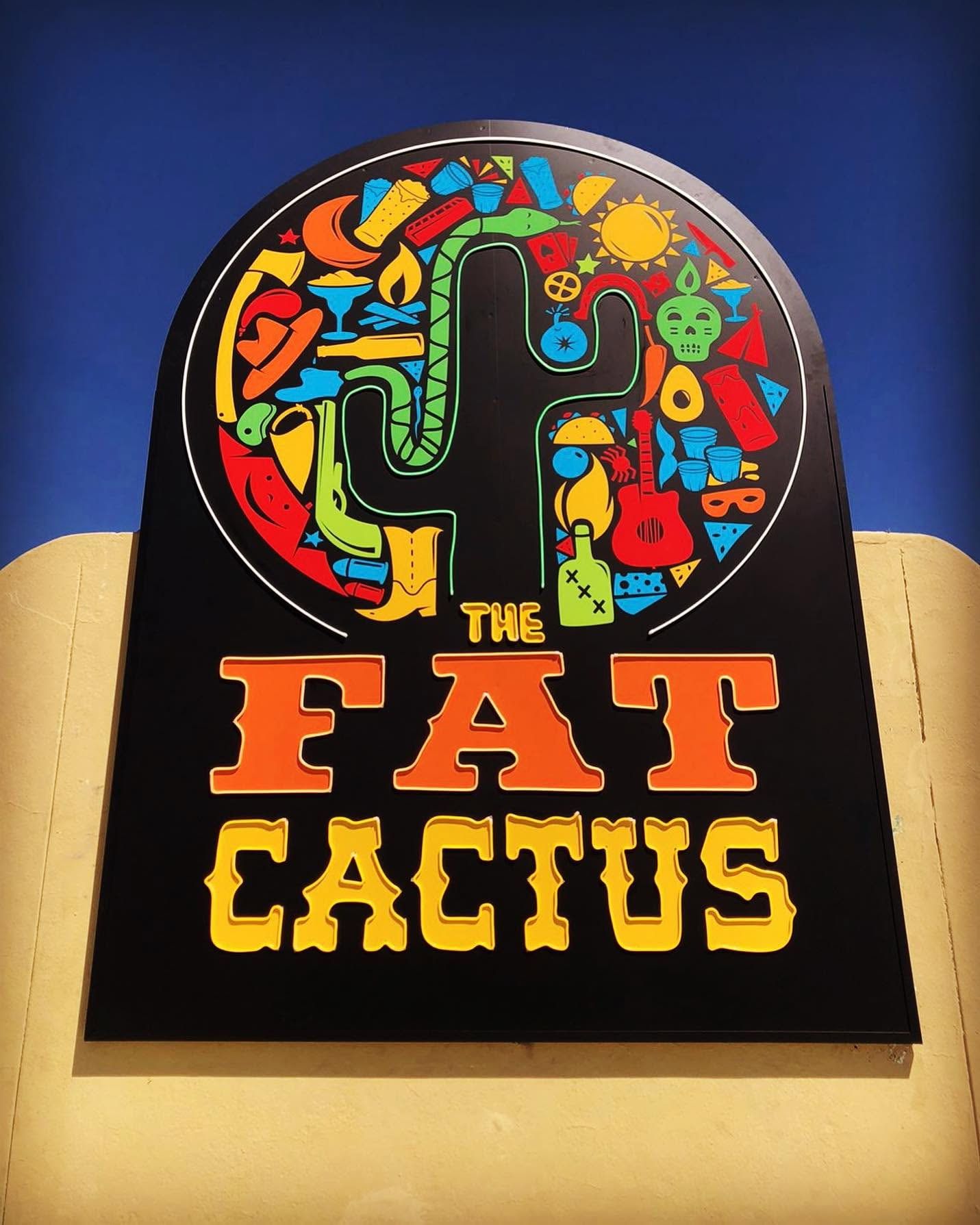 The Fat Cactus restaurant sign with a colourful cactus in an arched black panel