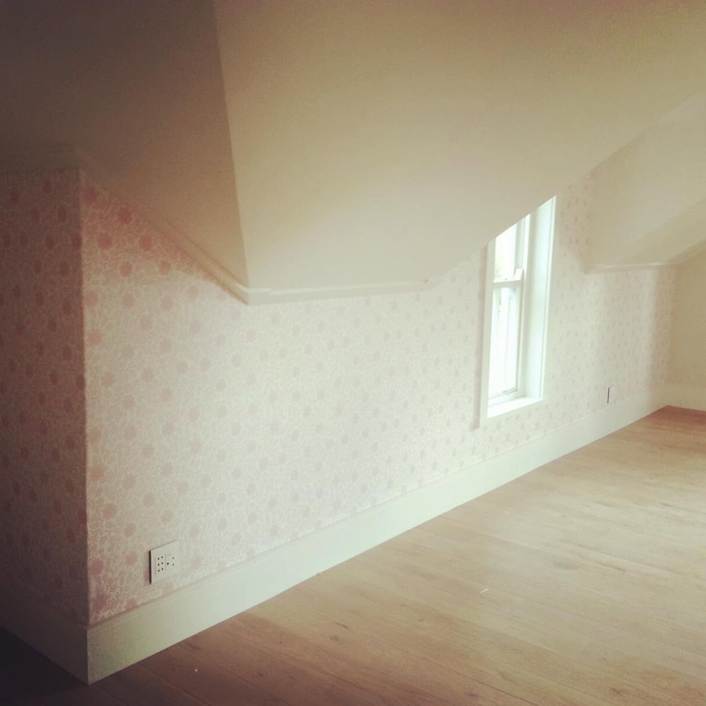 Subtle patterned wallpaper in a bedroom under the eaves