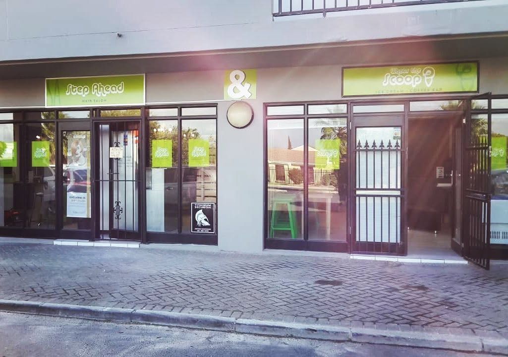 Salon shopfront with window graphics and fascia signage