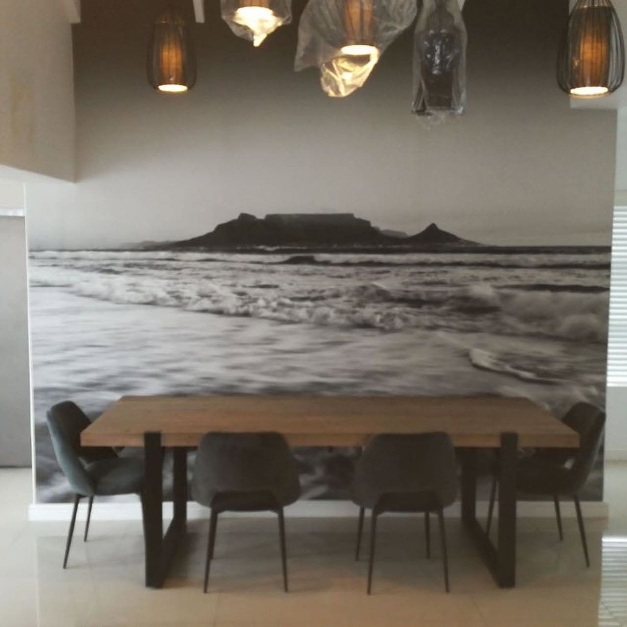 Boardroom table in front of a monochrome Table Mountain mural