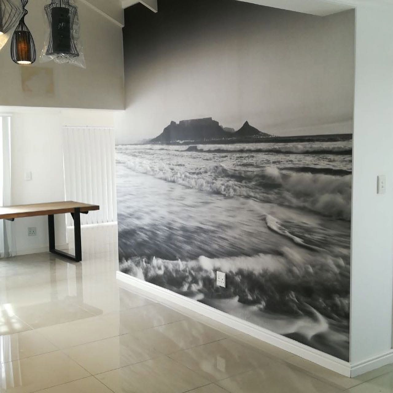 Black and white Table Mountain and surf mural in an office