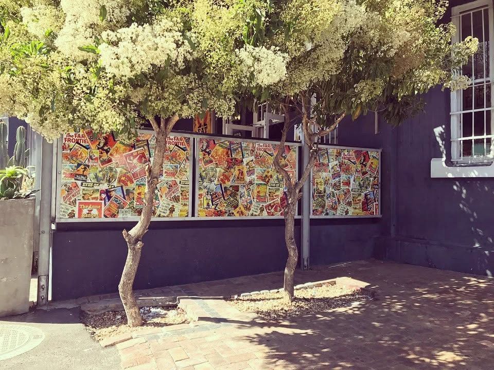 Vintage poster collage panels printed for an outdoor courtyard screen