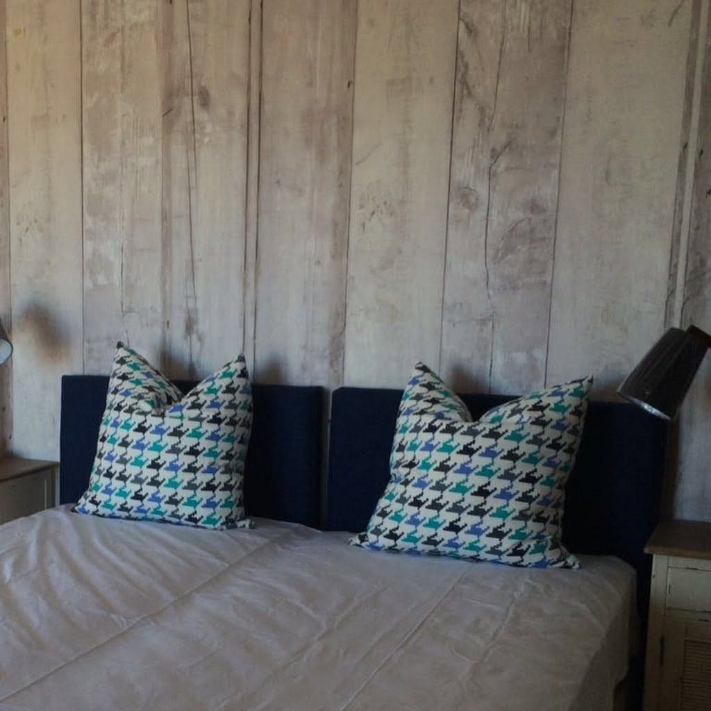 Wood plank wallpaper behind a daybed