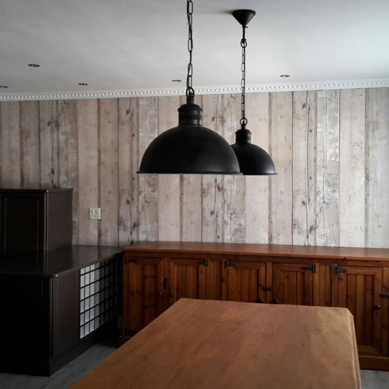 Weathered wood plank wallpaper in a kitchen with pendant lights
