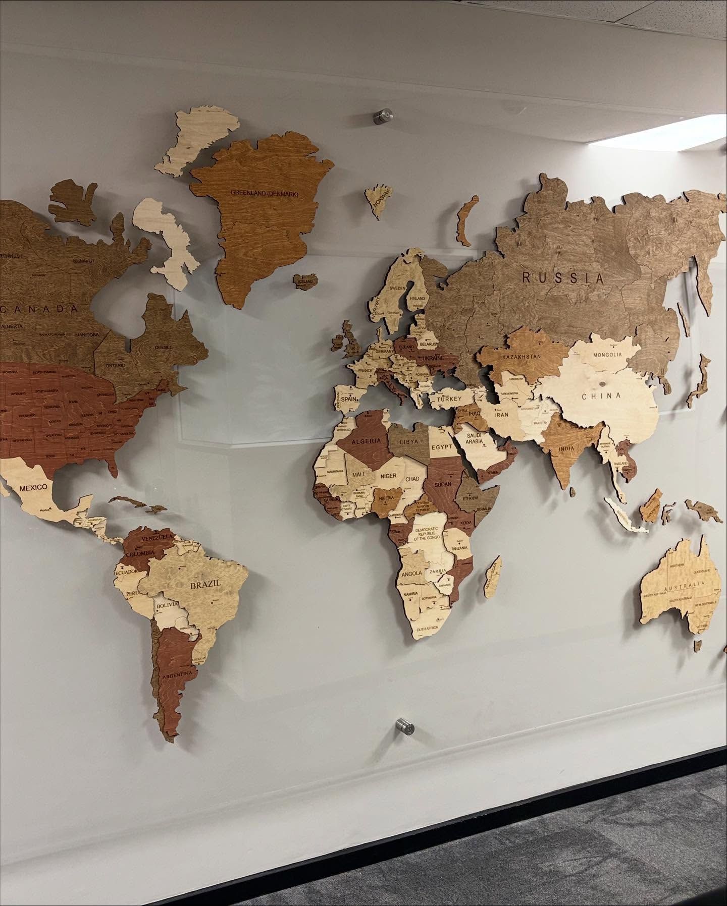Close view of a multi-tone laser-cut wooden world map